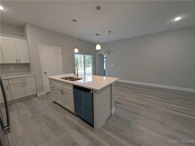 kitchen with pendant lighting, sink, dishwasher, white cabinetry, and a center island with sink