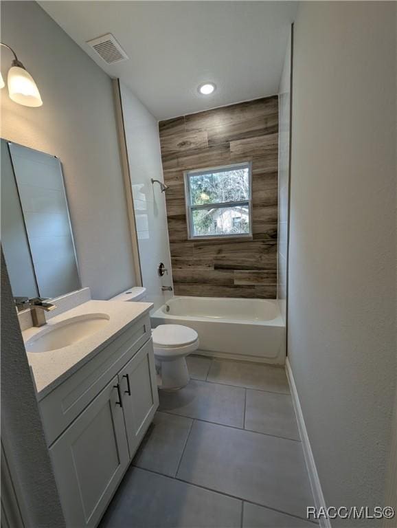 full bathroom with vanity, toilet, tiled shower / bath combo, and tile patterned flooring