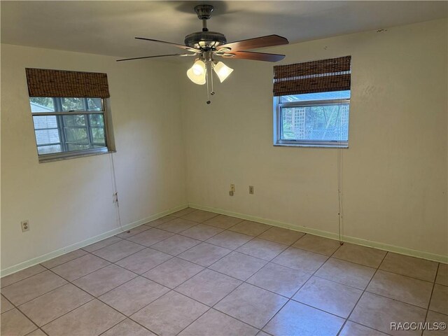 438 S Camillia Ave, Crystal River, FL 34429 - empty room with healthy amount of natural light, light tile patterned flooring, and ceiling fan
