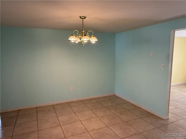 438 S Camillia Ave, Crystal River, FL 34429 - spare room featuring light tile patterned floors and a chandelier