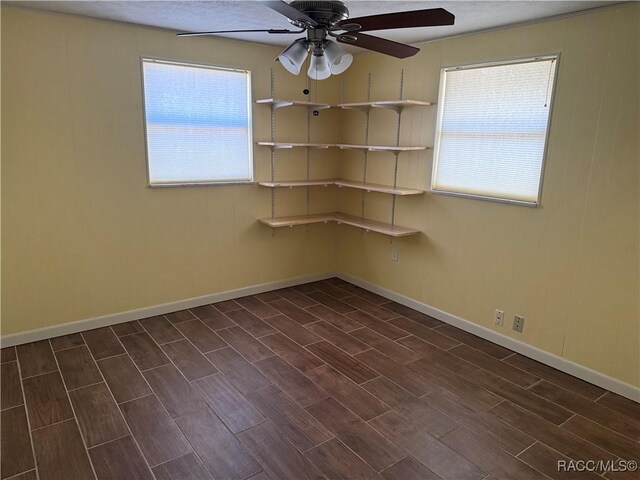 438 S Camillia Ave, Crystal River, FL 34429 - unfurnished room featuring ceiling fan and dark wood-type flooring
