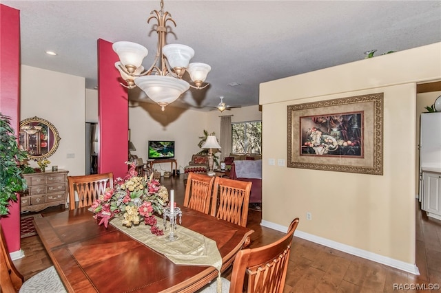 dining room featuring ceiling fan with notable chandelier, dark hardwood / wood-style floors, and a textured ceiling