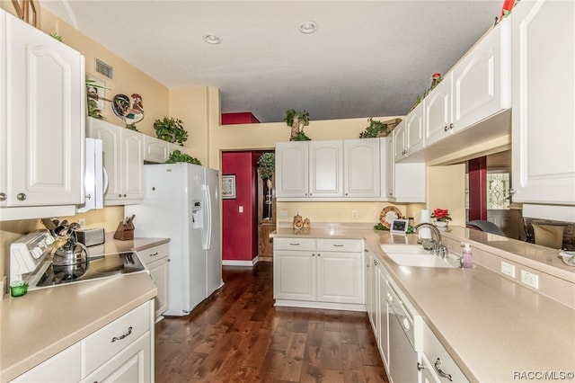 kitchen with white cabinets, dark hardwood / wood-style floors, sink, and appliances with stainless steel finishes