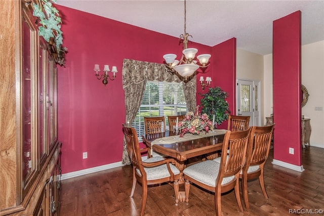 dining area featuring dark hardwood / wood-style floors and an inviting chandelier