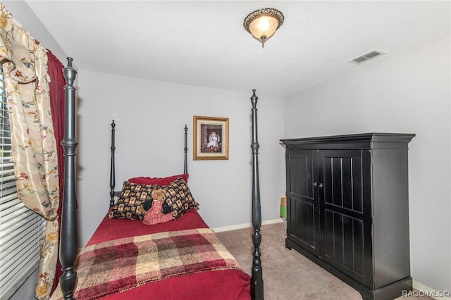 bedroom with carpet flooring and a textured ceiling