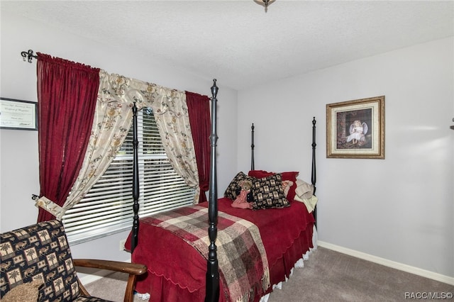 bedroom with carpet and a textured ceiling