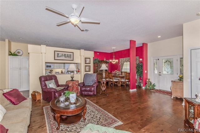 living room featuring ceiling fan and dark hardwood / wood-style flooring