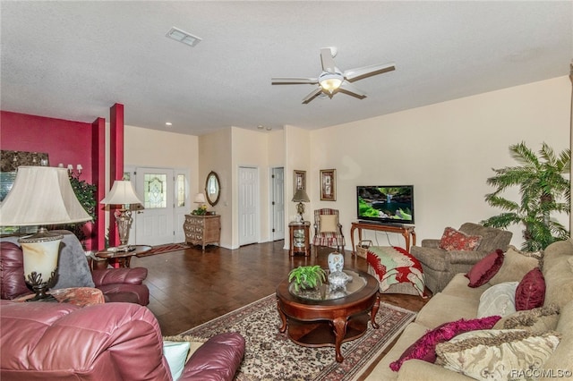 living room with ceiling fan, wood-type flooring, and a textured ceiling