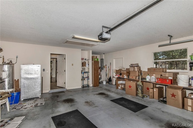 garage featuring refrigerator, a garage door opener, and water heater