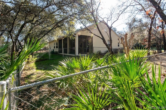 view of side of home featuring a sunroom