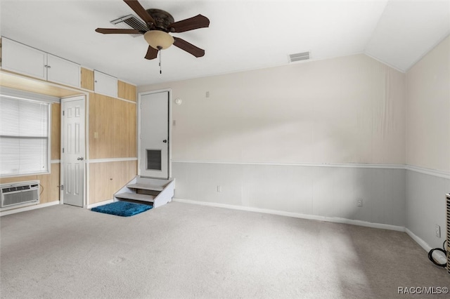 unfurnished living room with ceiling fan, light colored carpet, and vaulted ceiling