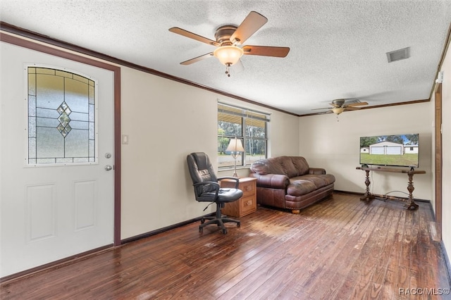 foyer entrance with wood-type flooring, a textured ceiling, and ceiling fan