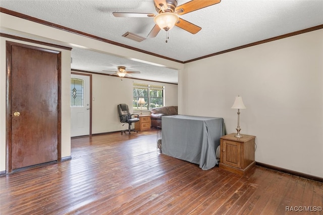 living room with ceiling fan, wood-type flooring, a textured ceiling, and ornamental molding