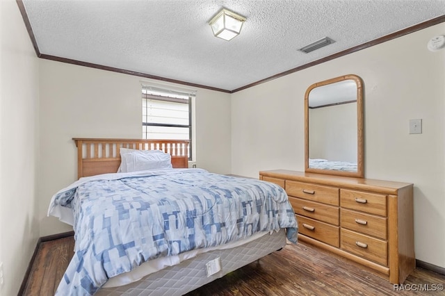 bedroom with a textured ceiling, crown molding, and dark hardwood / wood-style floors