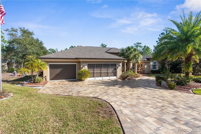 ranch-style home with a garage and a front yard