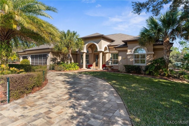 mediterranean / spanish home with a front yard