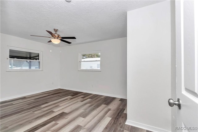 9019 E Gulf To Lake Hwy, Inverness, FL 34450 - unfurnished room with wood finished floors, a ceiling fan, and a textured ceiling