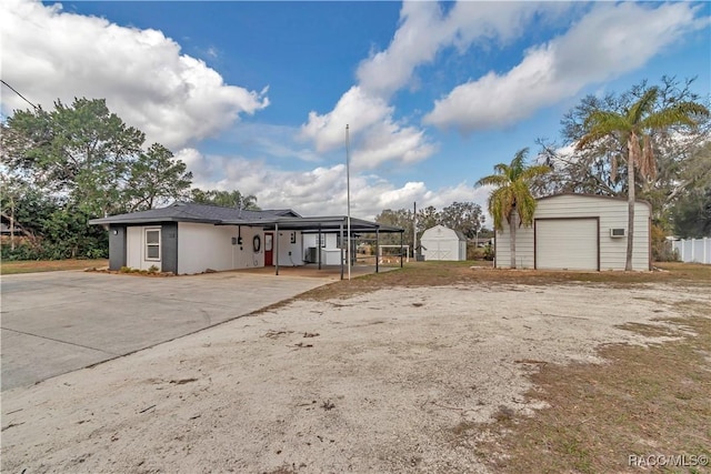 9019 E Gulf To Lake Hwy, Inverness, FL 34450 - view of front of house featuring a detached garage, a storage shed, and driveway