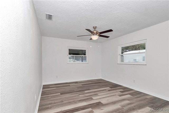 9019 E Gulf To Lake Hwy, Inverness, FL 34450 - spare room with a ceiling fan, wood finished floors, and a textured ceiling