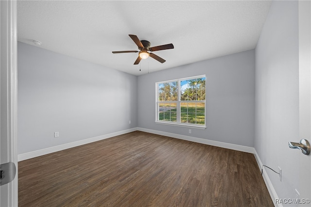 spare room featuring a textured ceiling, dark hardwood / wood-style floors, and ceiling fan