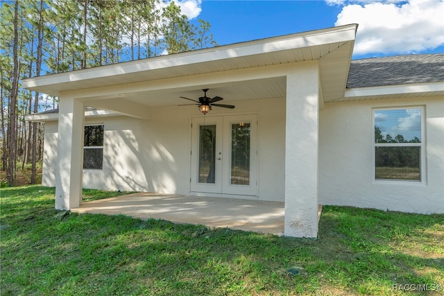 doorway to property with a yard, a patio, and ceiling fan