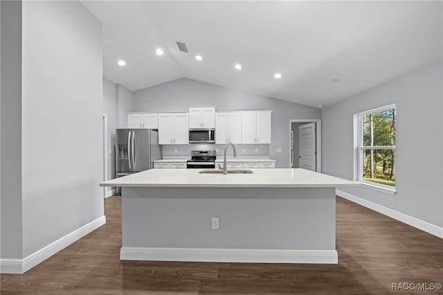 kitchen featuring white cabinetry, sink, an island with sink, lofted ceiling, and appliances with stainless steel finishes