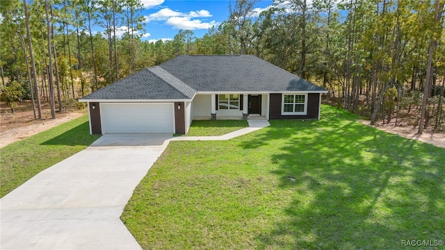 view of front of property with a front yard and a garage