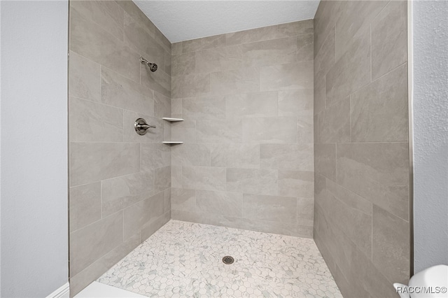 bathroom with a tile shower