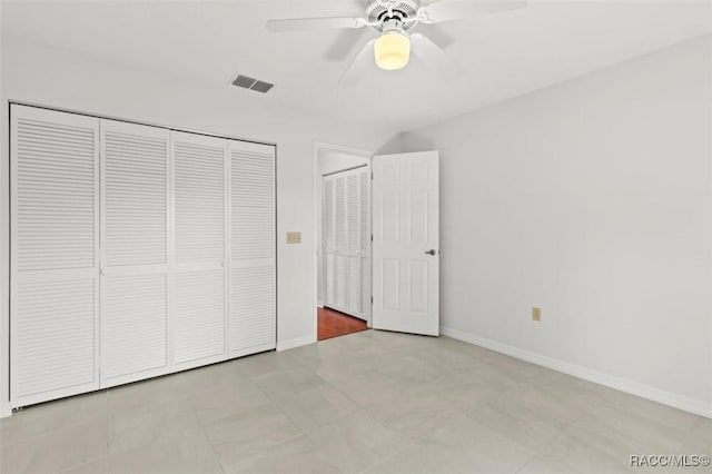 unfurnished bedroom with a closet, ceiling fan, and light tile patterned flooring