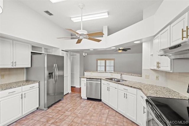 kitchen with white cabinetry, sink, light stone counters, and appliances with stainless steel finishes