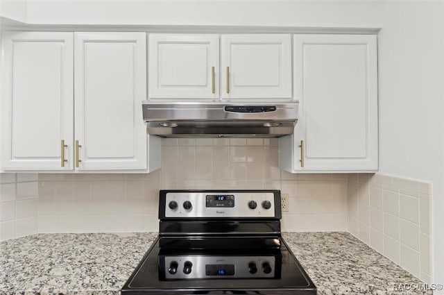 kitchen featuring decorative backsplash, white cabinets, light stone counters, and stainless steel electric range