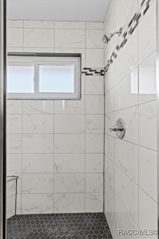 bathroom with tiled shower