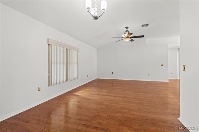 unfurnished room with ceiling fan with notable chandelier, lofted ceiling, and hardwood / wood-style floors