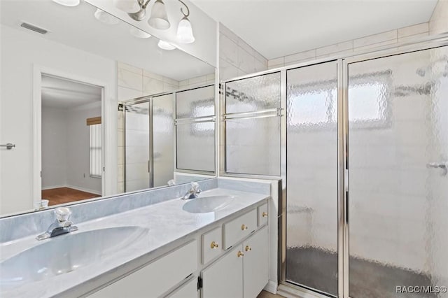 bathroom featuring vanity and an enclosed shower