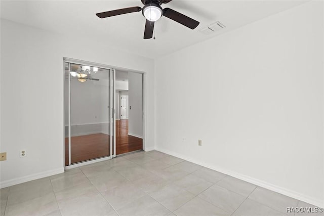 unfurnished bedroom with a closet, ceiling fan, and light tile patterned flooring