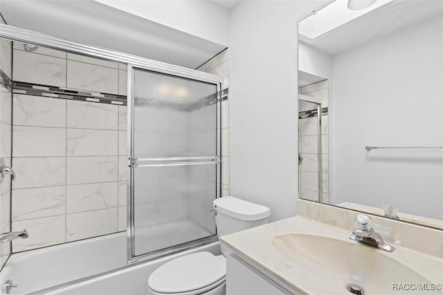 full bathroom with toilet, vanity, and shower / bath combination with glass door