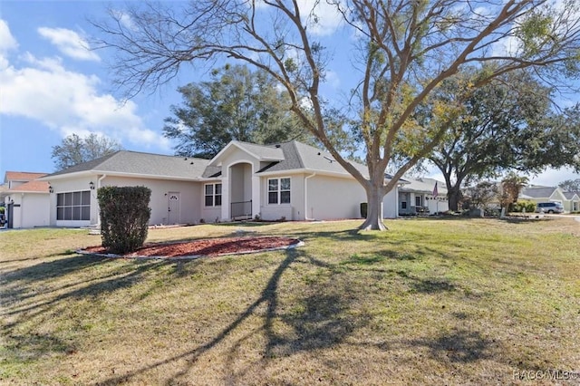 rear view of house featuring a lawn