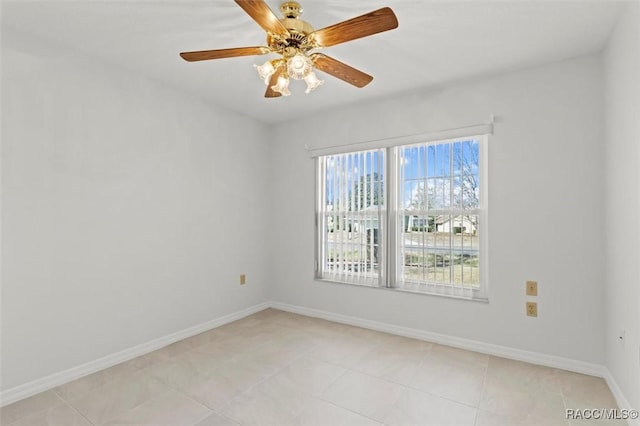 spare room featuring light tile patterned floors and ceiling fan