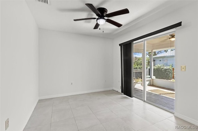 tiled spare room with ceiling fan