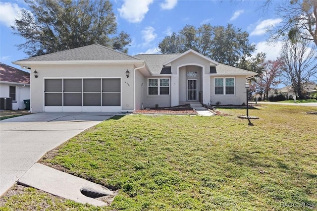 single story home with central AC, a garage, and a front lawn