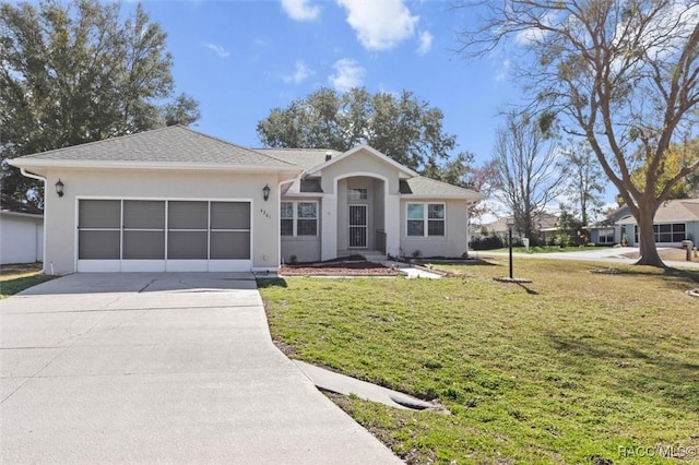 single story home featuring a garage and a front lawn