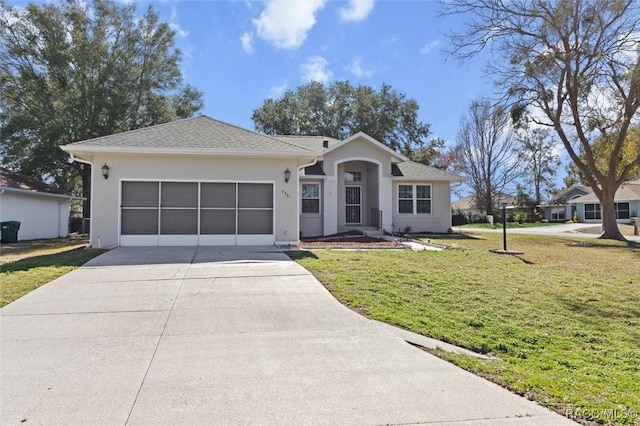 single story home featuring a garage and a front yard