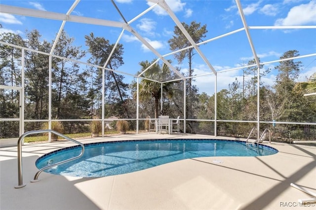 outdoor pool featuring a patio area and glass enclosure