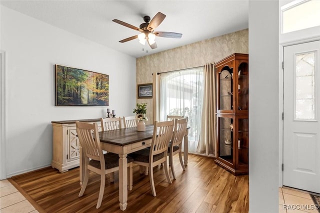 dining space with light wood-style flooring, a ceiling fan, and a wealth of natural light