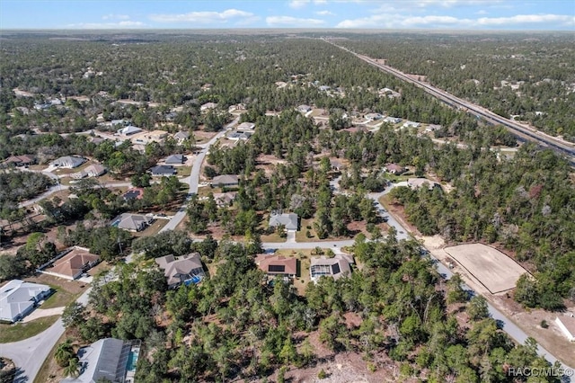 aerial view with a residential view and a wooded view