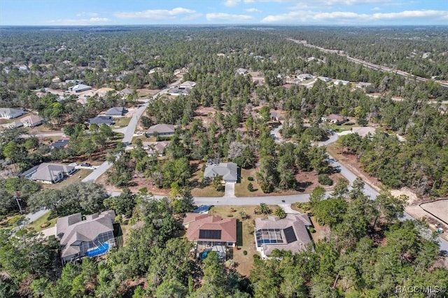 aerial view with a wooded view and a residential view