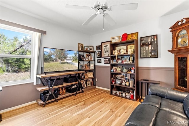 living room with light wood-style floors and a ceiling fan