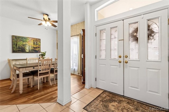 entrance foyer with light tile patterned floors and ceiling fan