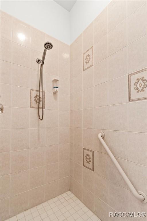 bathroom with a tile shower