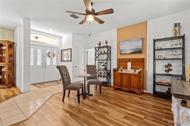 interior space with light wood-style flooring, visible vents, and ceiling fan